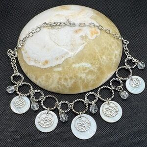 Avon Vintage signed  silvertone necklace with mother-of-pearl and lotus charms.
